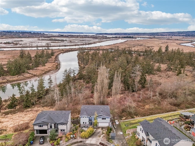 drone / aerial view featuring a water view and a residential view