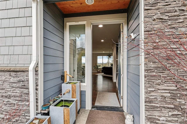 entrance to property featuring stone siding