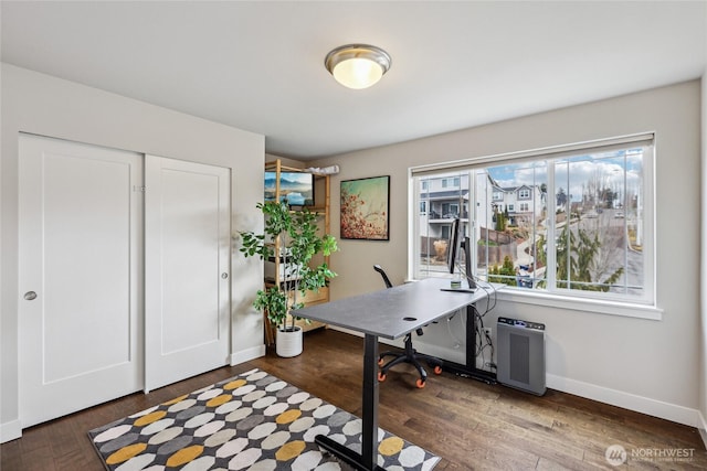 home office with dark wood-style floors, baseboards, and a wealth of natural light
