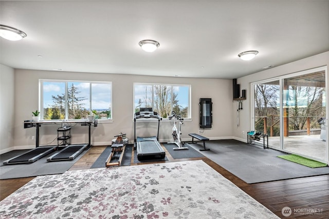 exercise area featuring dark wood-style floors and baseboards