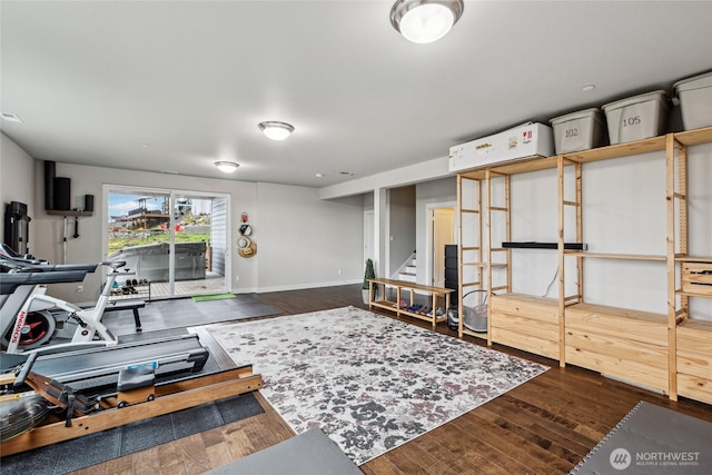exercise area with dark wood-type flooring, visible vents, and baseboards
