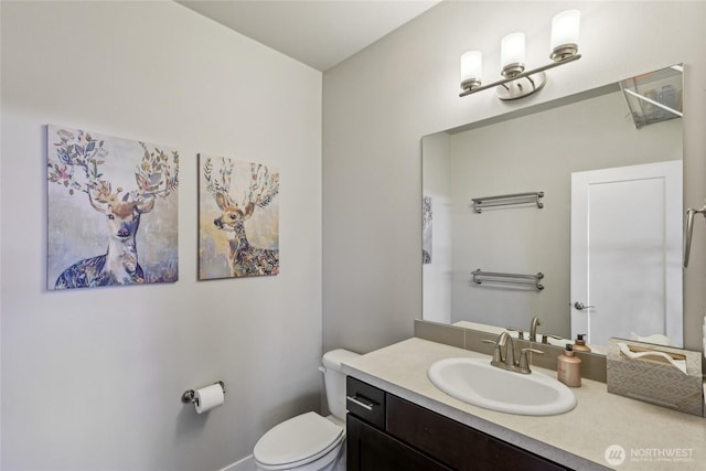 bathroom featuring vanity and toilet