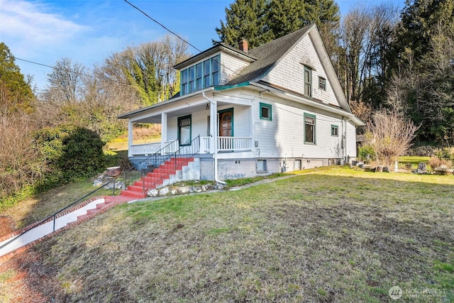 bungalow with a front yard and covered porch