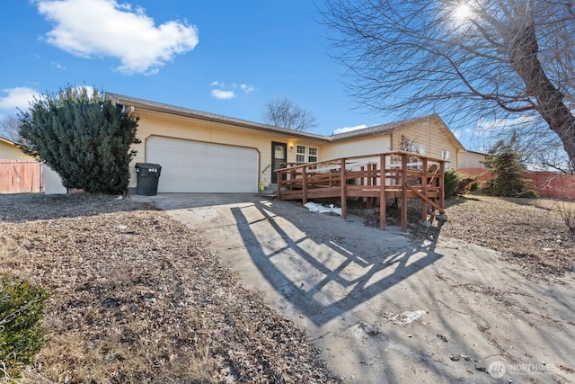 ranch-style home with a garage and a deck