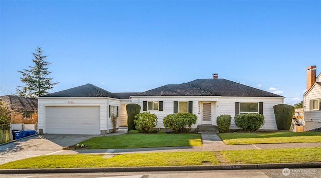 ranch-style home with a front lawn and a garage