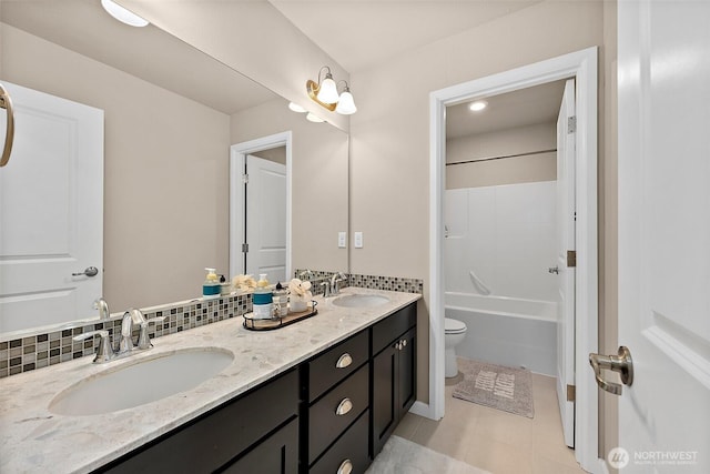 full bathroom with shower / bath combination, tile patterned flooring, tasteful backsplash, vanity, and toilet