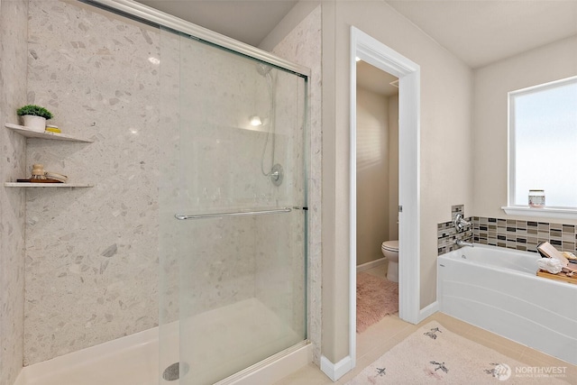 bathroom with independent shower and bath, tile patterned floors, and toilet