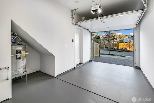 garage featuring secured water heater and a garage door opener