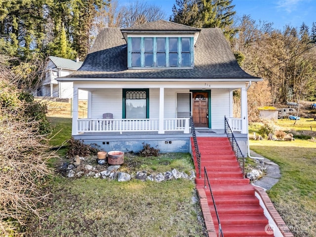 bungalow-style home with a porch and a front lawn