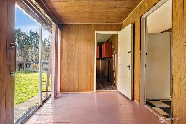 unfurnished sunroom with wood ceiling and plenty of natural light