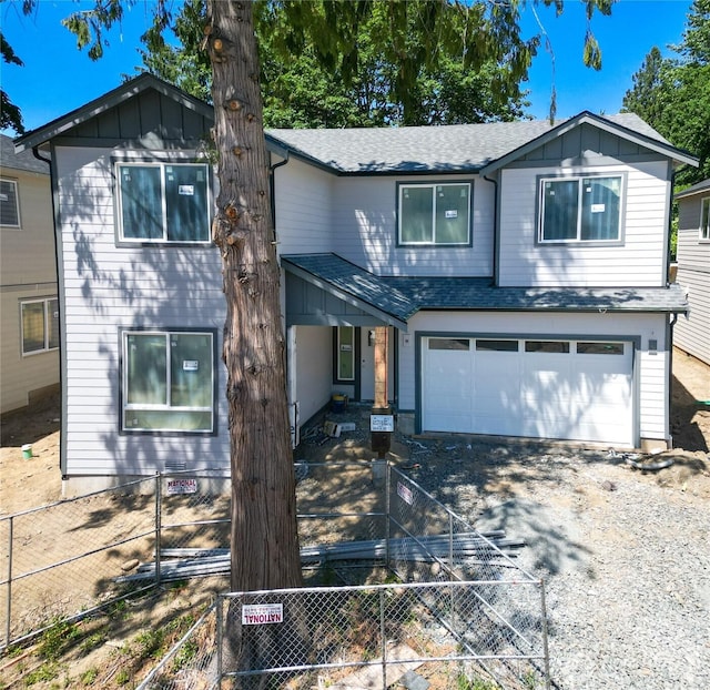 10676 SE 170th Pl-, Renton, WA 98055 - view of front of home featuring a shingled roof, driveway, a garage, and board and batten siding