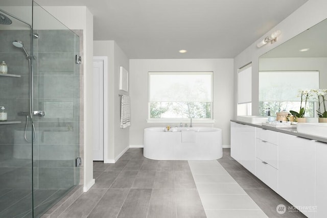 bathroom featuring vanity, separate shower and tub, and tile patterned floors