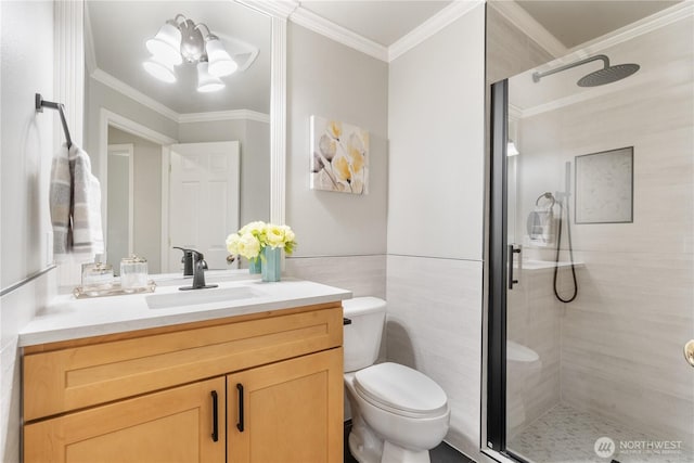 bathroom featuring an enclosed shower, ornamental molding, tile walls, toilet, and vanity