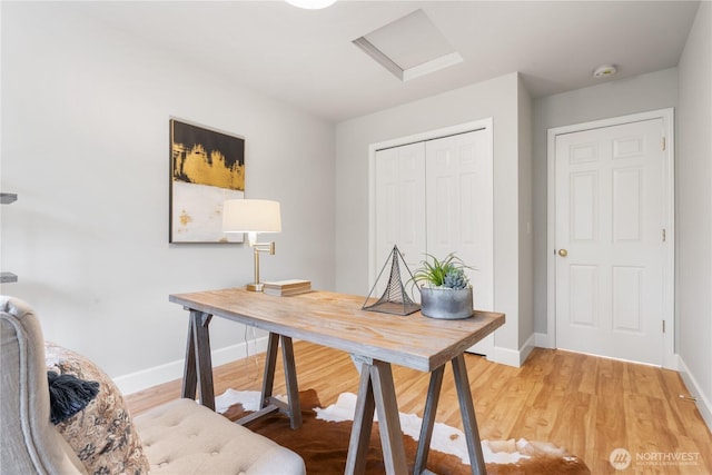 home office with light hardwood / wood-style flooring