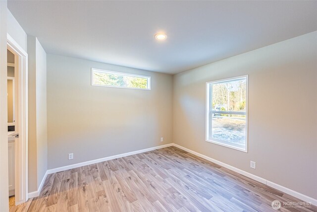 unfurnished room featuring light wood-style floors and baseboards