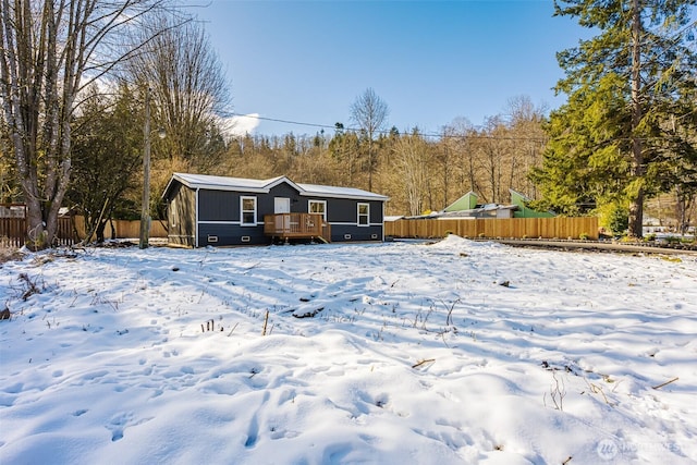 view of front of home featuring fence and a wooden deck