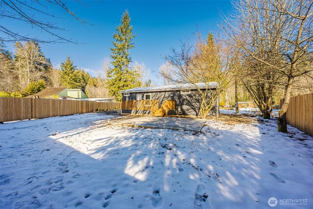 snowy yard with fence