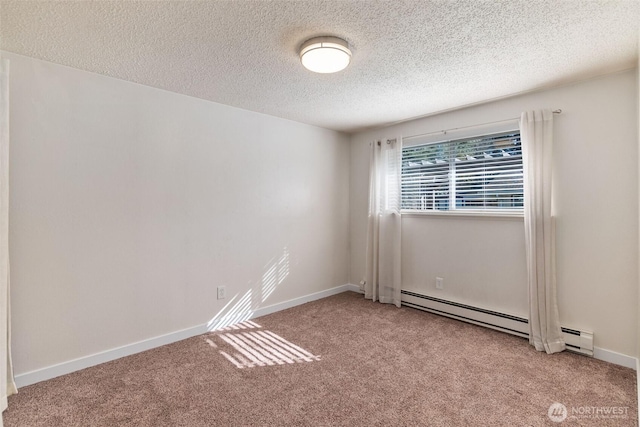 carpeted spare room with baseboards, baseboard heating, and a textured ceiling