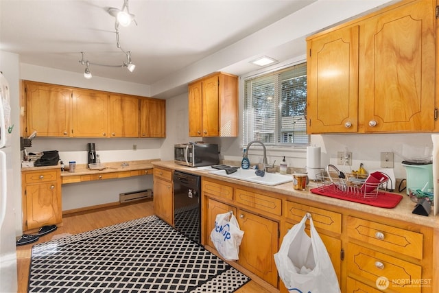 kitchen with stainless steel microwave, dishwasher, light wood-type flooring, light countertops, and a sink