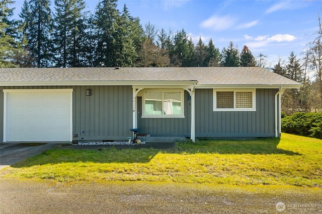 ranch-style house featuring driveway, a front yard, board and batten siding, and an attached garage