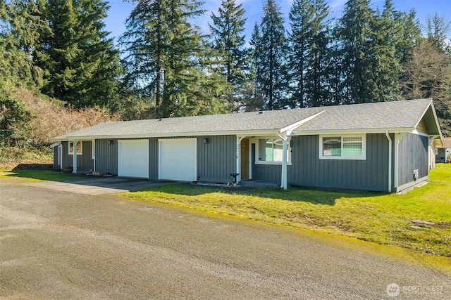 ranch-style house featuring a front lawn, a garage, and driveway