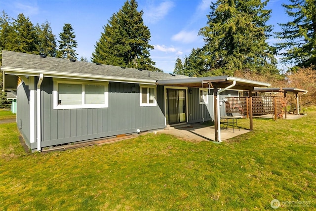 back of house with a patio and a lawn