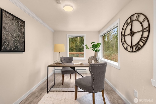 office space with ornamental molding and light hardwood / wood-style floors