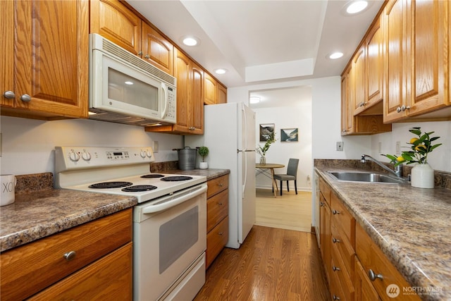 3710 25th Pl W Unit 401, Seattle, WA 98199 - kitchen featuring white appliances, a sink, dark wood finished floors, brown cabinetry, and recessed lighting