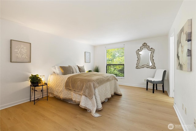 3710 25th Pl W Unit 401, Seattle, WA 98199 - bedroom with light wood-style floors and baseboards