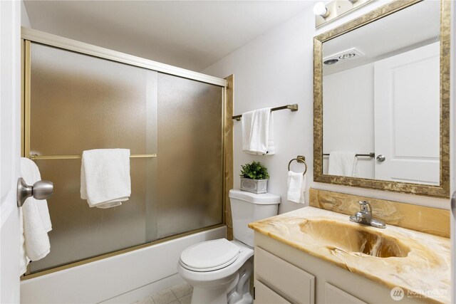 3710 25th Pl W Unit 401, Seattle, WA 98199 - bathroom with vanity, toilet, bath / shower combo with glass door, and tile patterned flooring