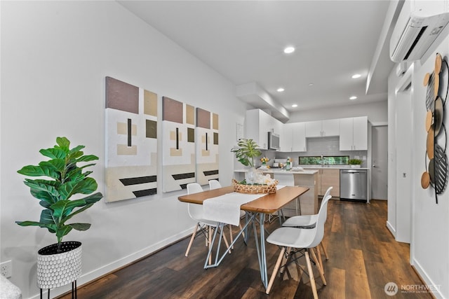 dining space featuring sink, dark wood-type flooring, and a wall unit AC