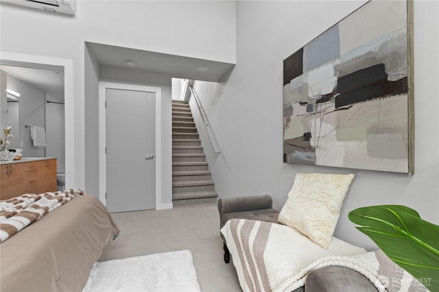 carpeted bedroom featuring ensuite bathroom and a closet