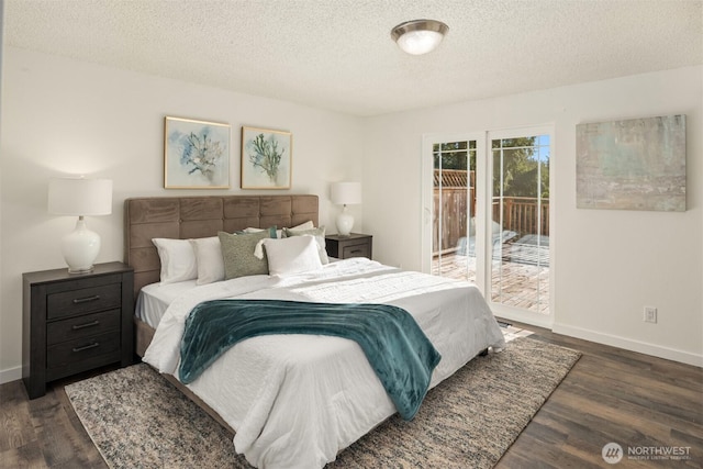 bedroom with dark hardwood / wood-style flooring, access to outside, and a textured ceiling