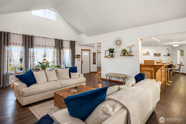 living area with high vaulted ceiling, dark wood-style flooring, and baseboards