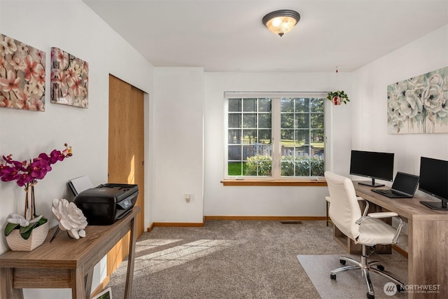 office featuring carpet flooring, visible vents, and baseboards