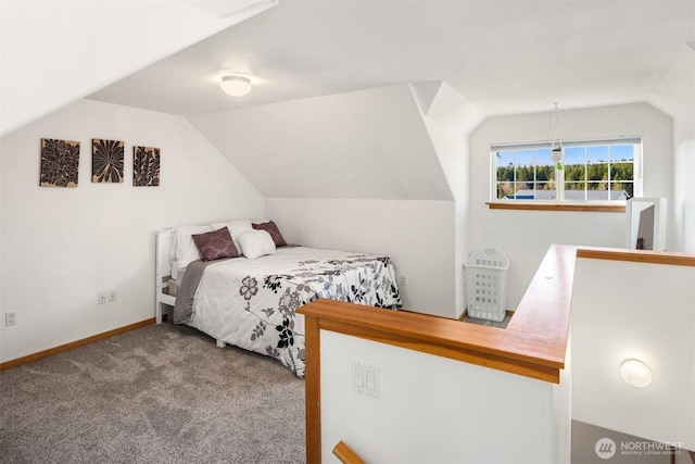 carpeted bedroom featuring vaulted ceiling and baseboards