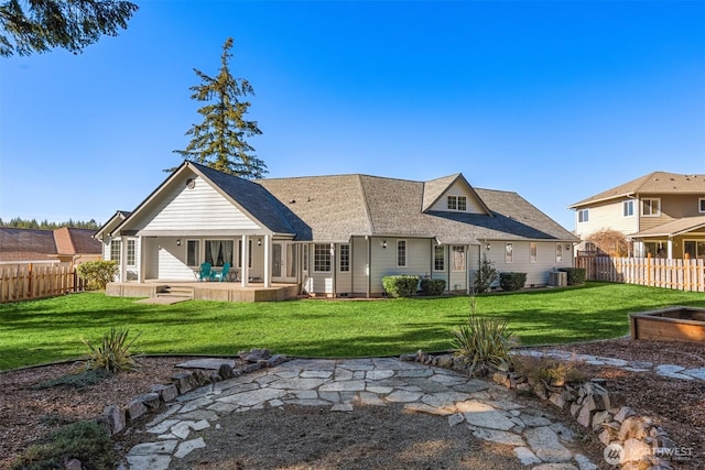 back of property with a yard, a patio area, fence, and central AC unit