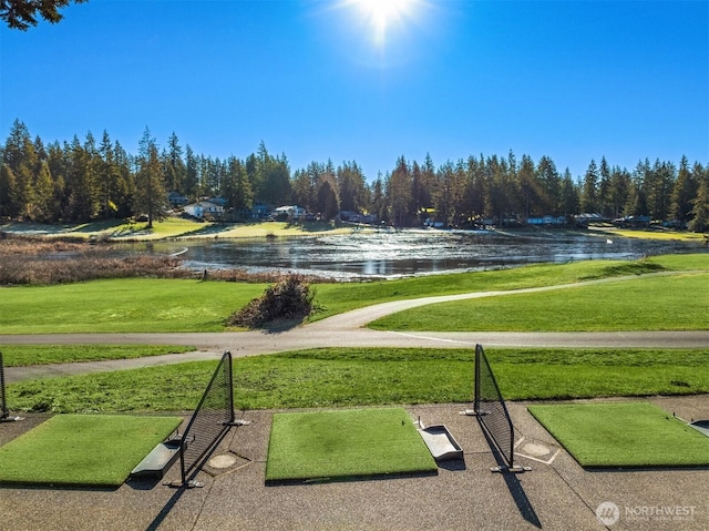 view of community with a water view and a lawn