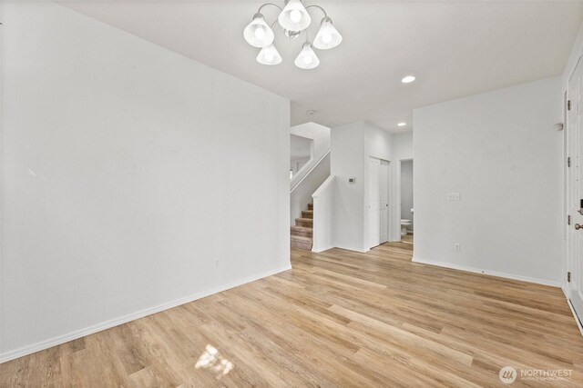 5401 Parkside Dr SE, Lacey, WA 98503 - unfurnished room with stairway, light wood-style floors, a chandelier, and recessed lighting