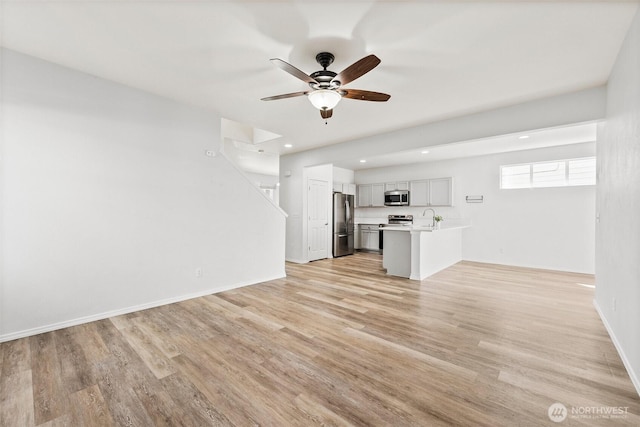 5401 Parkside Dr SE, Lacey, WA 98503 - unfurnished living room featuring light wood-type flooring, a ceiling fan, and recessed lighting
