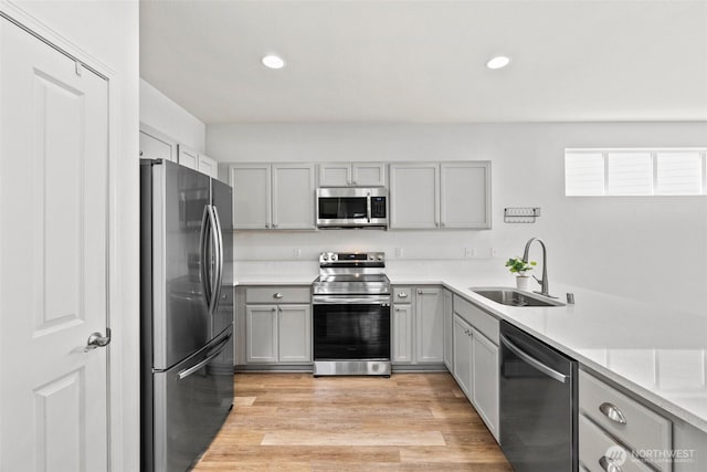 5401 Parkside Dr SE, Lacey, WA 98503 - kitchen featuring stainless steel appliances, gray cabinetry, recessed lighting, light countertops, and light wood finished floors