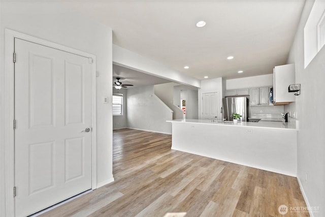 5401 Parkside Dr SE, Lacey, WA 98503 - kitchen with appliances with stainless steel finishes, a peninsula, light wood-style flooring, ceiling fan, and recessed lighting