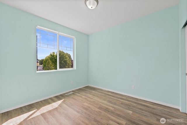 5401 Parkside Dr SE, Lacey, WA 98503 - spare room featuring wood finished floors and baseboards