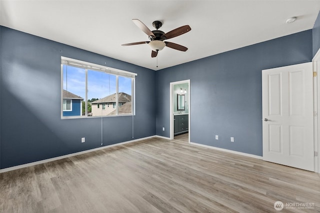 5401 Parkside Dr SE, Lacey, WA 98503 - unfurnished bedroom with wood finished floors, ensuite bath, and a ceiling fan