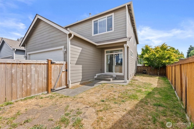 5401 Parkside Dr SE, Lacey, WA 98503 - back of property with a fenced backyard, a gate, and a garage