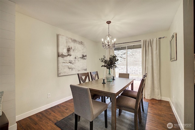 dining room with dark hardwood / wood-style floors and a chandelier