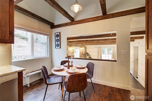 dining space featuring vaulted ceiling with beams and dark hardwood / wood-style floors