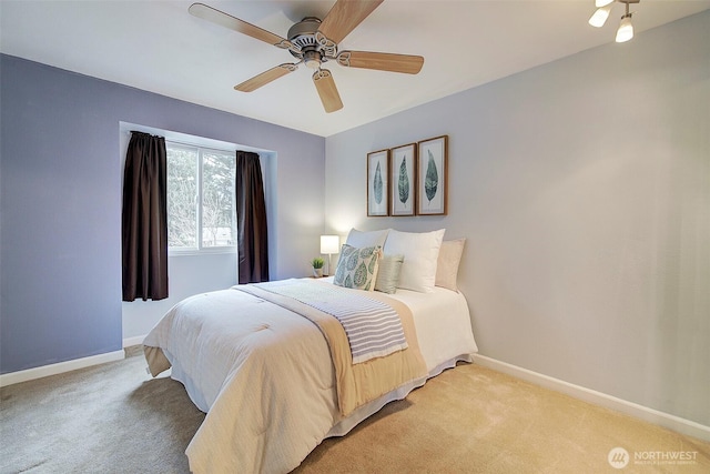 bedroom featuring light carpet and ceiling fan