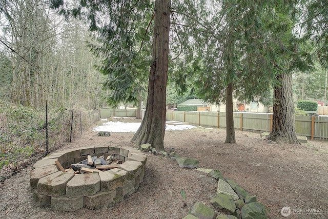 view of yard with an outdoor fire pit