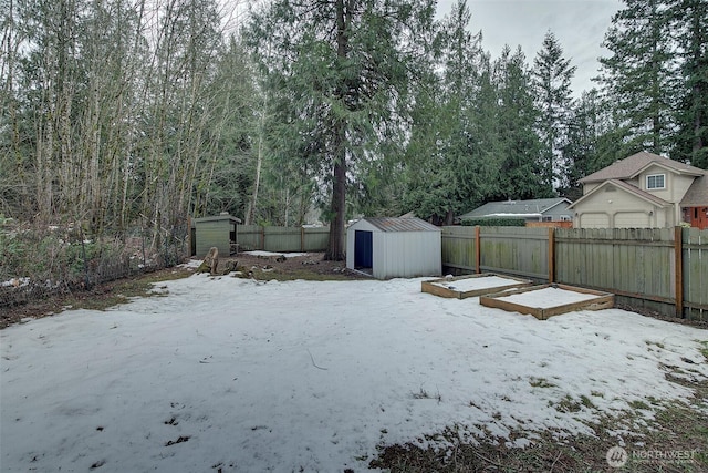 snowy yard with a storage shed